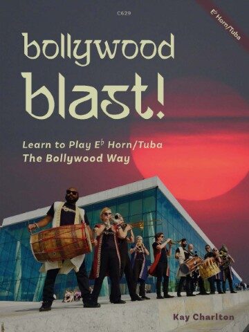 A book cover titled "bollywood blast!" with "Learn to Play Eb Horn/Tuba The Bollywood Way" and "Kay Charlton" at the bottom. The image features a group of musicians playing instruments, including a dhol drum and brass instruments, in front of a modern building with a red sky in the background. "C629" is in the top center, and "Eb Horn/Tuba" is diagonally in the top right corner.