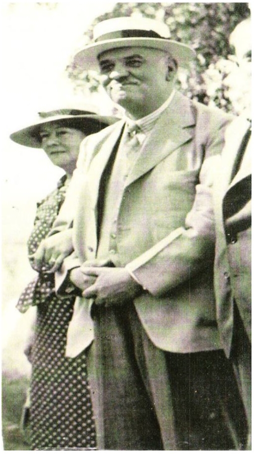 Black and white image of composer Adolf Lotter wearing a straw hat and accompanied by a woman