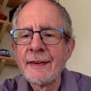 Colour photograph of composer Alan Bullard wearing his glasses.