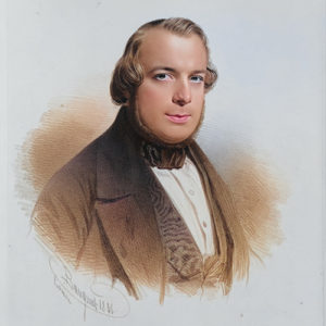 Image of composer Apollon Marie-Rose Barret wearing a brown jacker and a grey background.