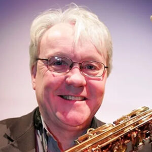Colour photograph of composer Jeffrey Wilson holding a saxophone