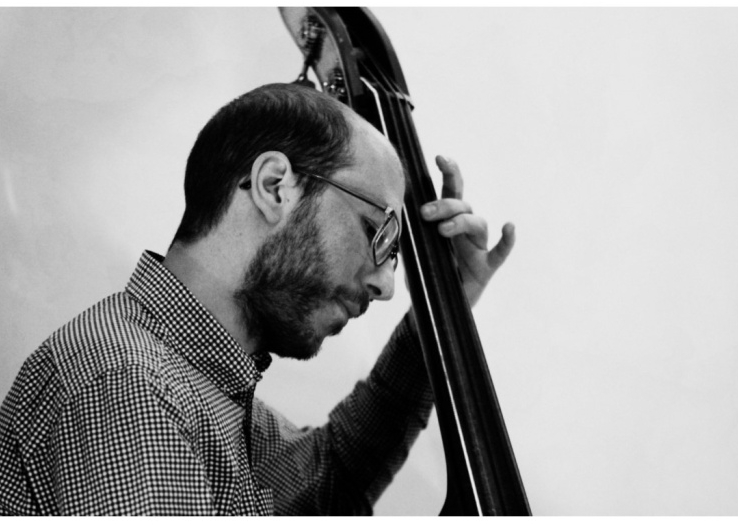 Image of the composer Sebastian Beliah playing the double bass.