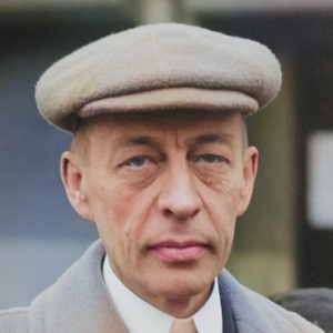 Photograph of Russian composer Serge Rachmaninov wearing a flat cap