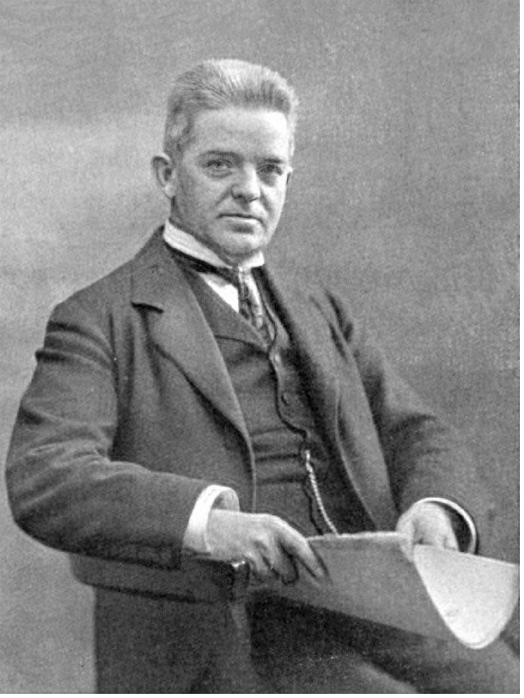 Portrait of Danish composer Carl Nielsen sat down and holding a manuscipt