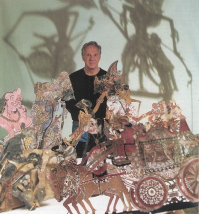 Robert Moran with Javanese wayang kulit puppets. Wayang is a traditional form of puppet theatre from Indonesia and Malaysia, with wayang kulit specifically referring to shadow puppetry.
