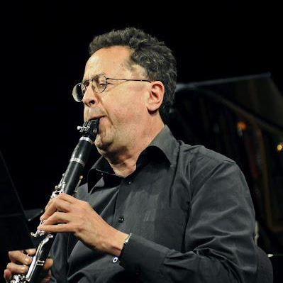 Photograph of composer Rubern Greenberg playing a clarinet.