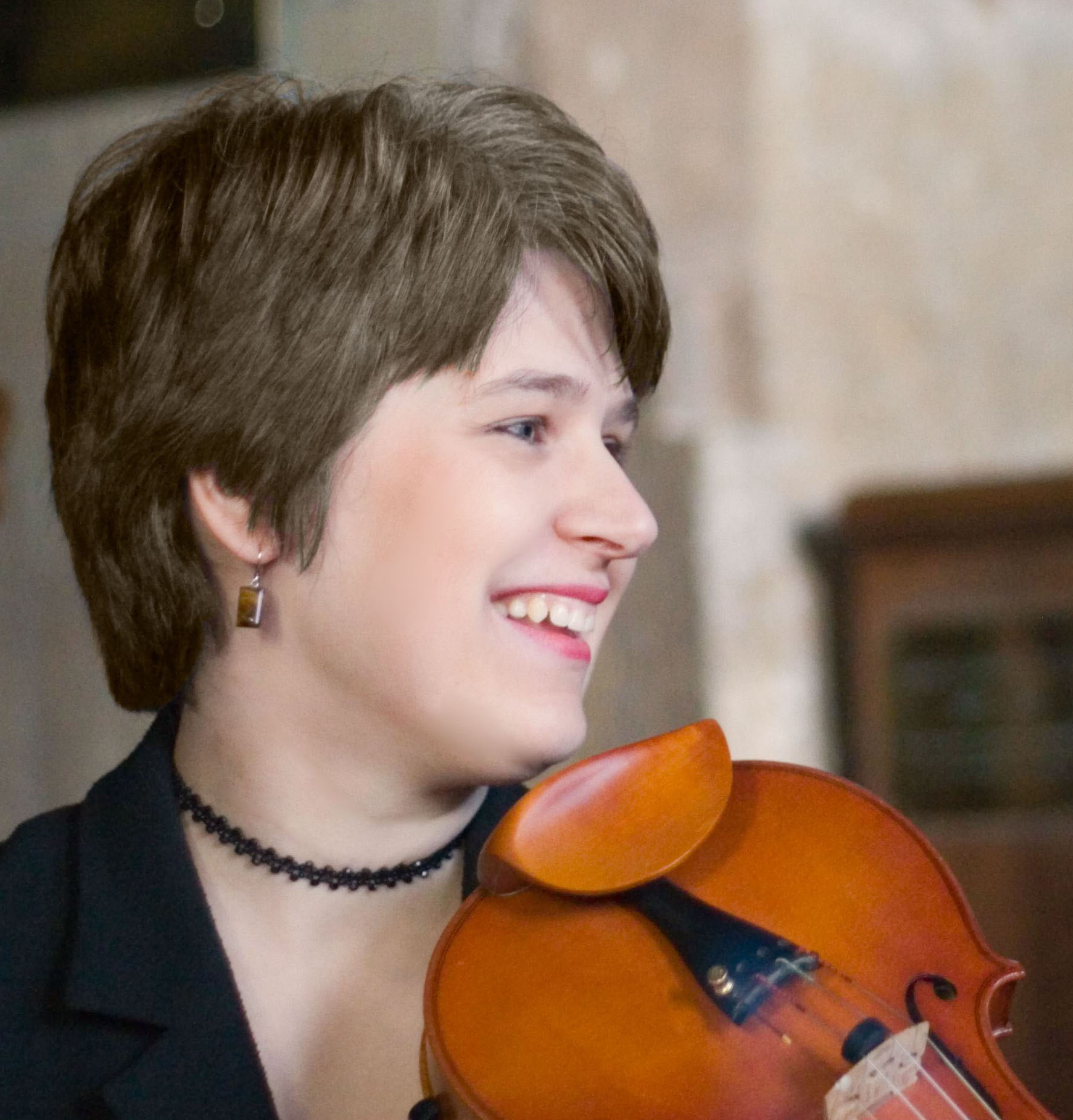 Colour photo of composer and violinist Georgia Vale holder her violin