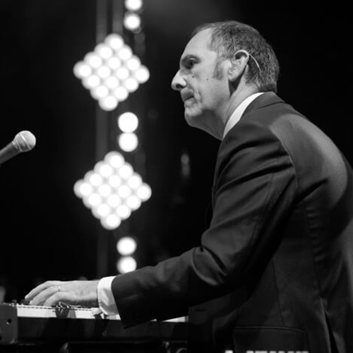 Adelman, Mark 1 Black and wite image of jass composer Mark Adelman playing the piano,